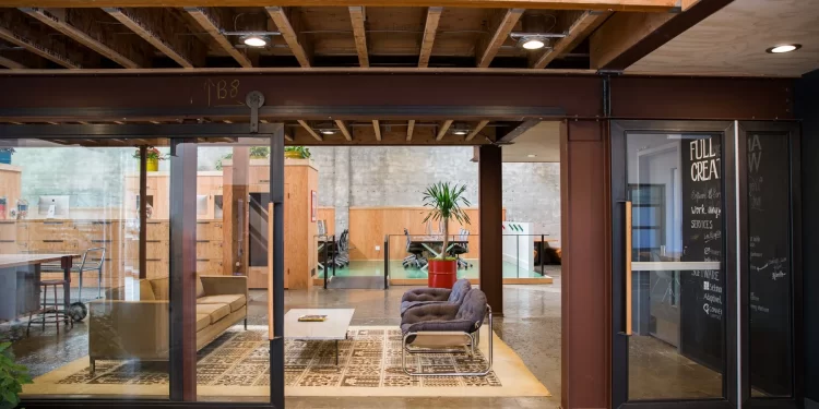 Modern office space designed for human connection: open layout, natural light, modular zones, and collaboration areas.