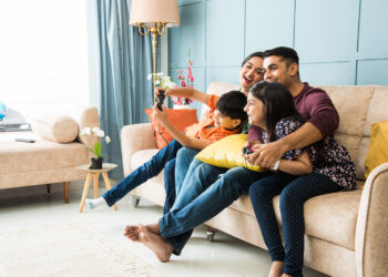 oung South Asian woman enjoying a mindful tea break in a cozy home setting, representing lifestyle and wellness trends in India.