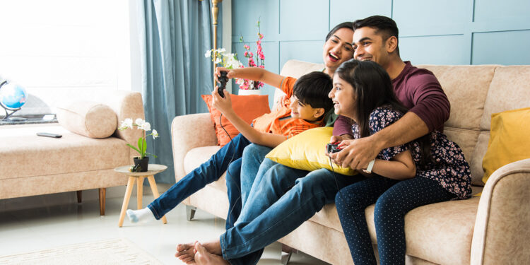 oung South Asian woman enjoying a mindful tea break in a cozy home setting, representing lifestyle and wellness trends in India.